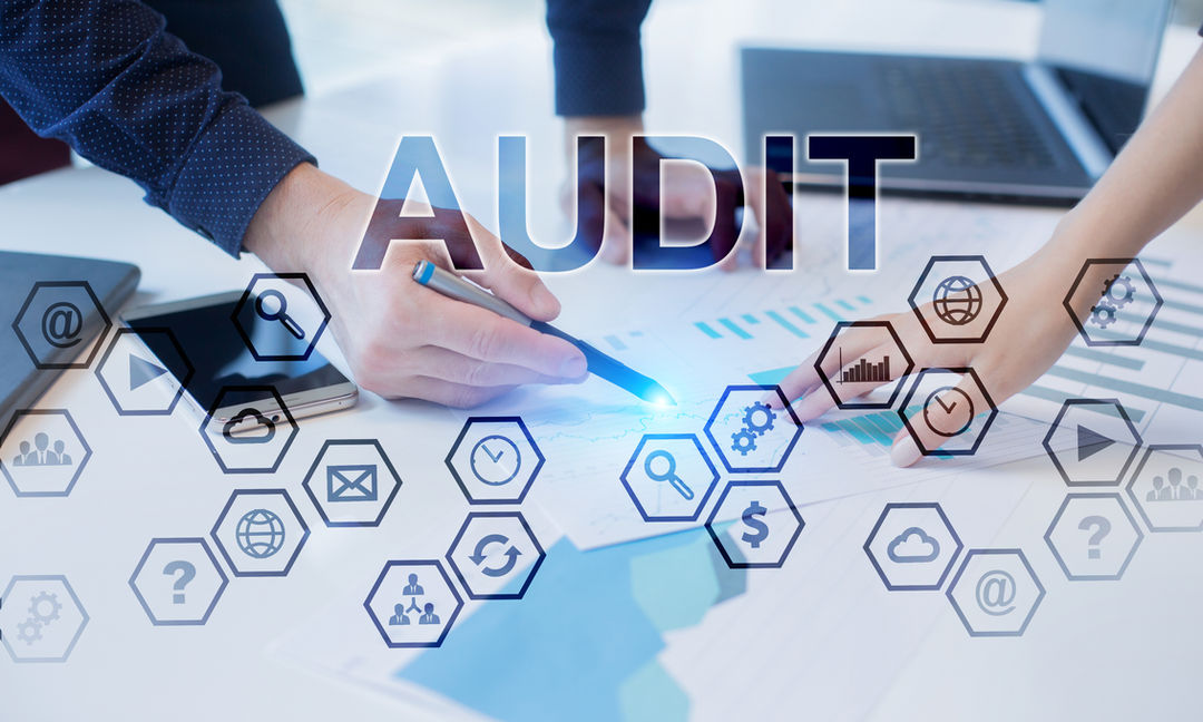 2 people working together on an audit document